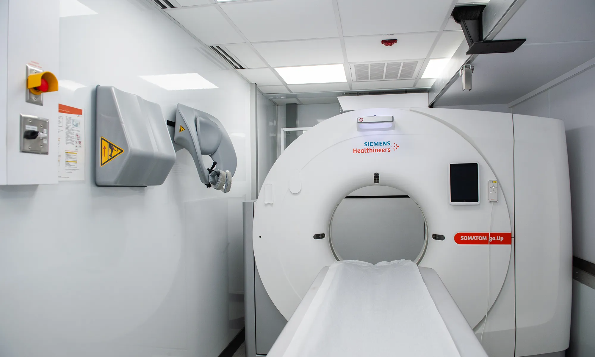 A Siemens Healthineers low-dose CT scanner inside the mobile health screening van.