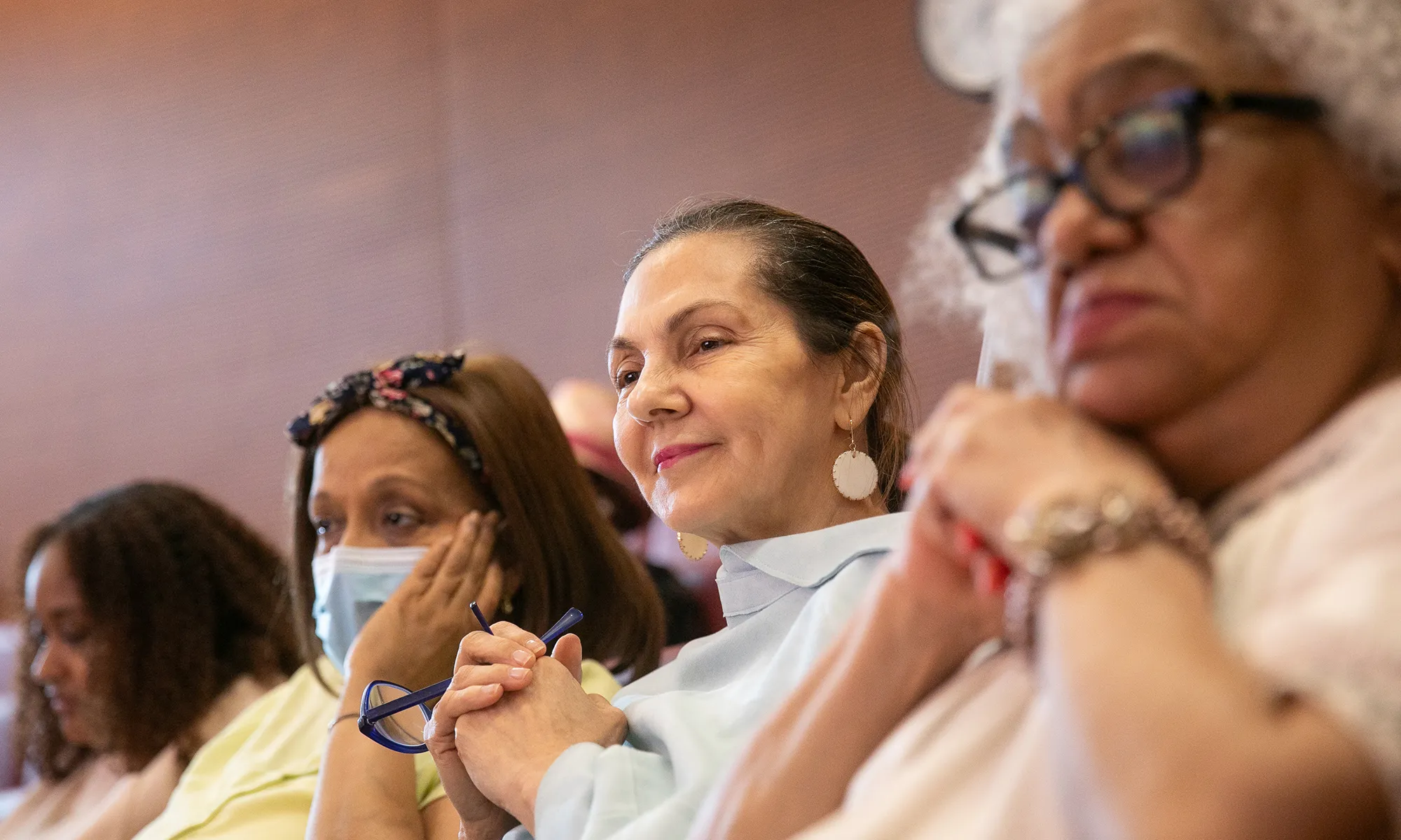 Four women are pictures seated in the Irving Cancer Research Center auditorium, listening closely during the Cancer Survivors Month event hosted by the Herbert Irving Comprehensive Cancer Center.